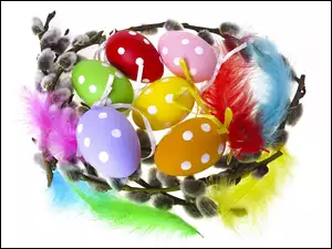 Wielkanocna dekoracja z pisanek i kolorowych piórek otoczonych baziami