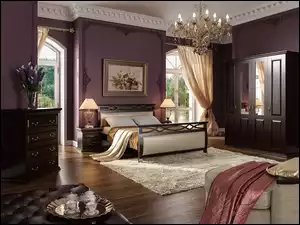 Umeblowana sypialnia z dużym łóżkiem i obrazem