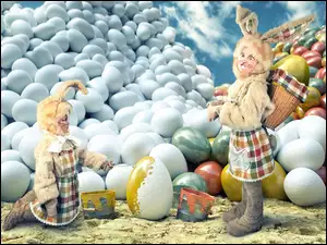 Dzieci w strojach króliczków malują jajka