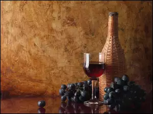Butelka i kieliszek wina z winogronami