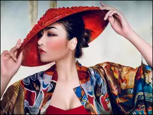 Azjatka poprawia czerwony kapelusz