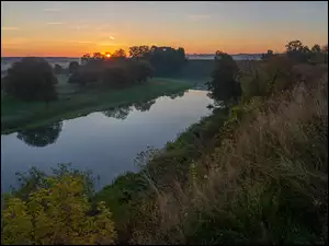 Wschód słońca nad rzeką i drzewami