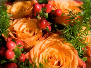 Bukiet pomarańczowych róż z dodatkami w blasku światła