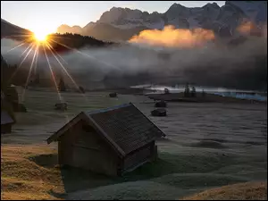Promienie słońca, Jezioro Geroldsee, Domki, Drzewa, Bawaria, Niemcy, Wzgórza, Góry Karwendel, Las, Mgła