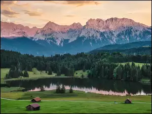 Szopy i trawa na polanie nad jeziorem Geroldsee u podnóża lasu i Alp Bawarskich