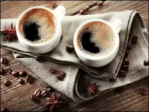 Dwa kubki kawy na płótnie z ziarnami