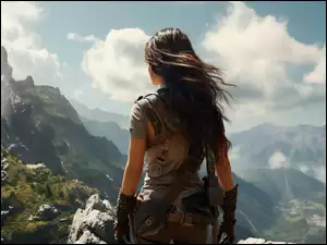 Widok z tyłu kobiety z rozwianymi włosami w górach