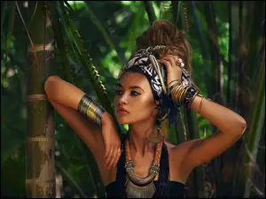 Piękna kobieta z biżuterią w bambusowym lesie