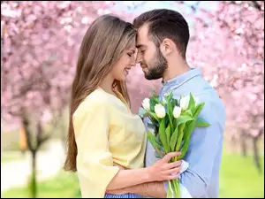 Para z kwiatami w parku