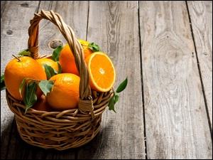 Kosz dojrzałych pomarańczy na deskach