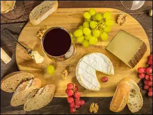 Chleb, ser, wino i winogrona na desce