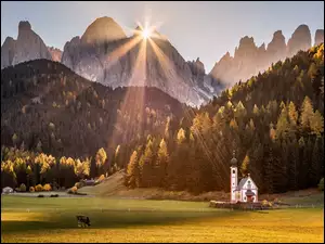 Kościół na tle Dolomitów w promieniach słońca