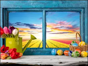 Wielkanocna dekoracja na oknie z tulipanami i pisankami