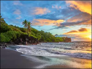 Wschód słońca nad morską plażą z palmami