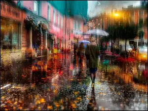 Ludzie pod parasolami idą ulicą podczas jesiennego deszczu