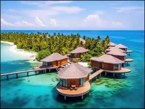 Wyspa na morzu z domkami i palmami